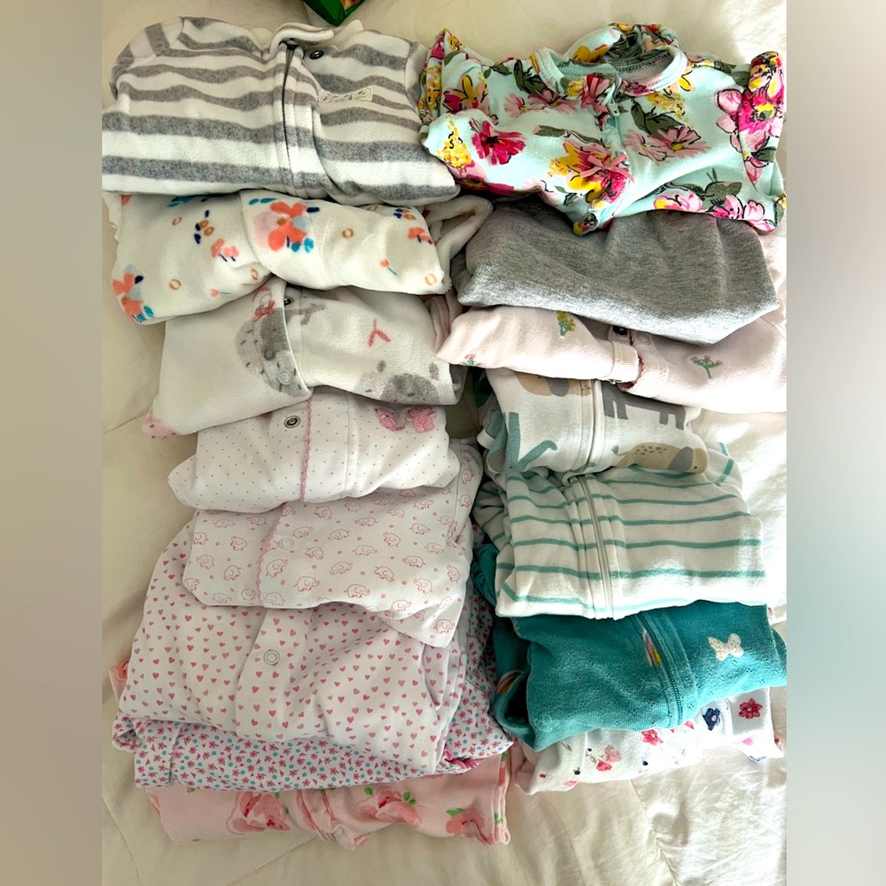 Assorted newborn footies. Brands include Kissy Kissy, Carters and Magnetic Me